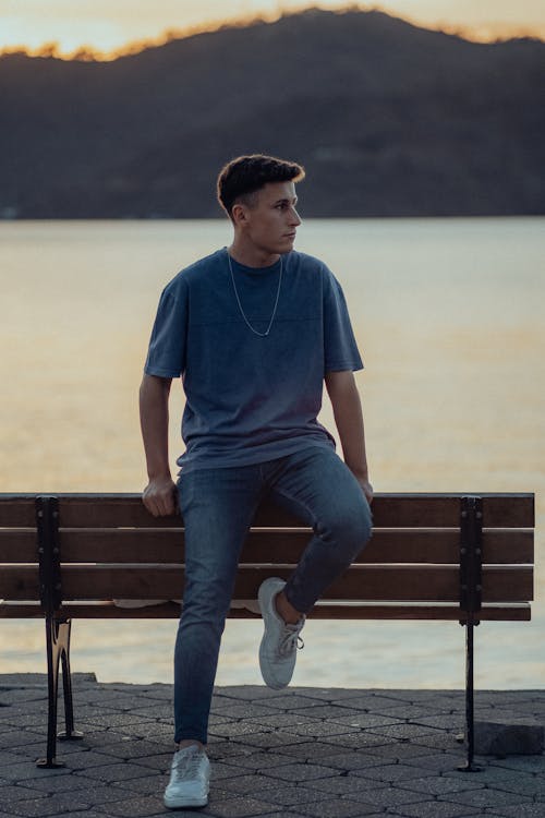 Man in T-shirt Posing on Bench