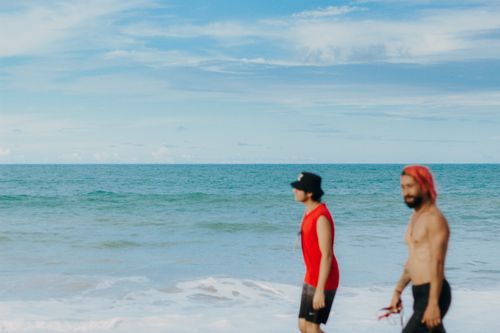 Free Two men enjoying a sunny day at Canoa Quebrada Beach, Brazil. Stock Photo