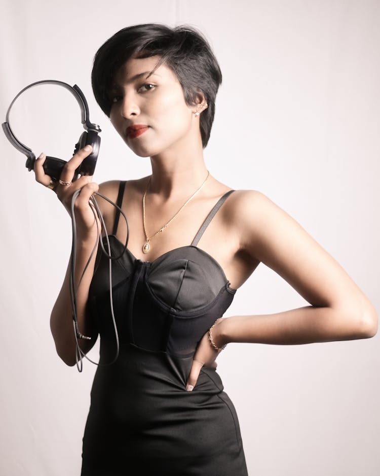 Woman In Black Dress Posing With Headphones