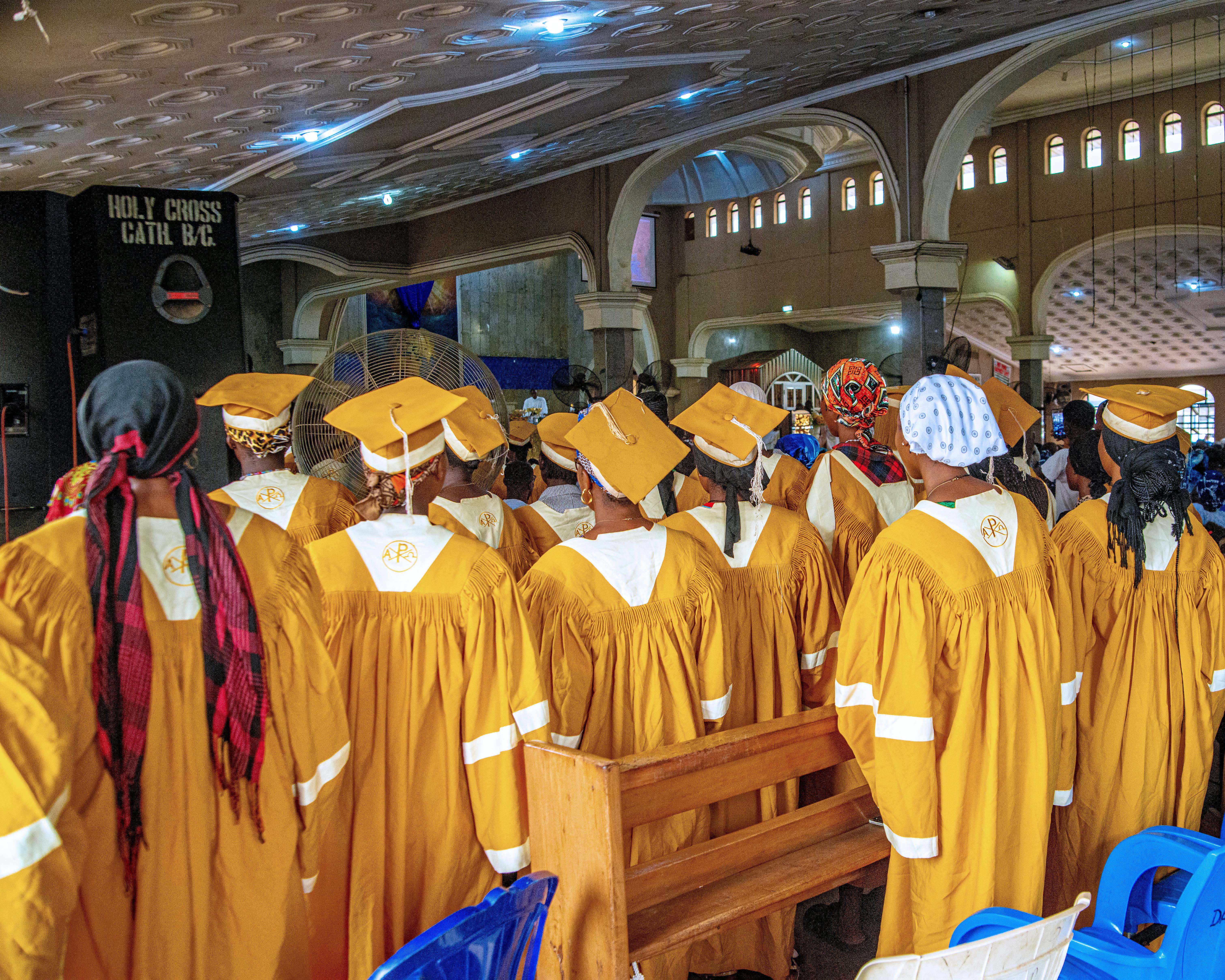 A vibrant choir in golden gowns sings during a ceremony at Holy Cross Cathedral, Benin City.