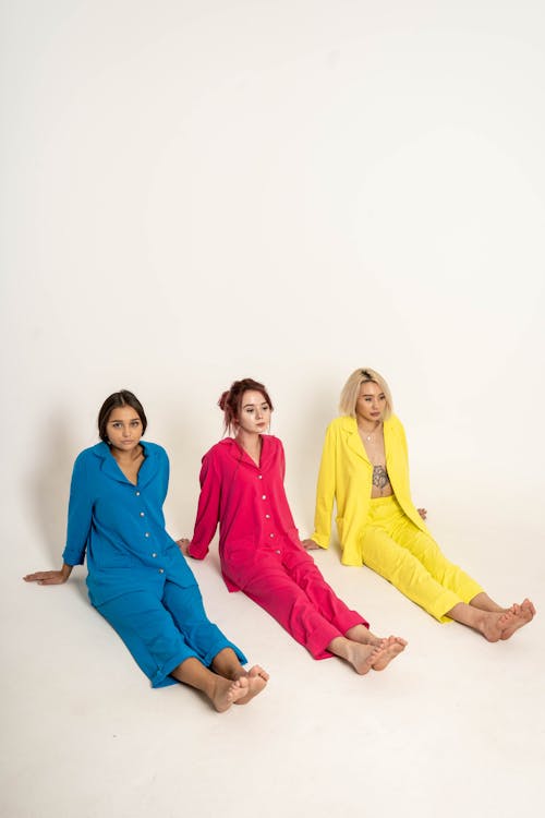 Women Sitting in Colorful Clothes