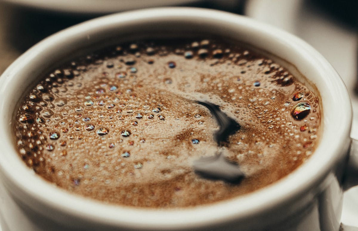 Close-up top view of a latte with foam art and cinnamon sprinkled on top
