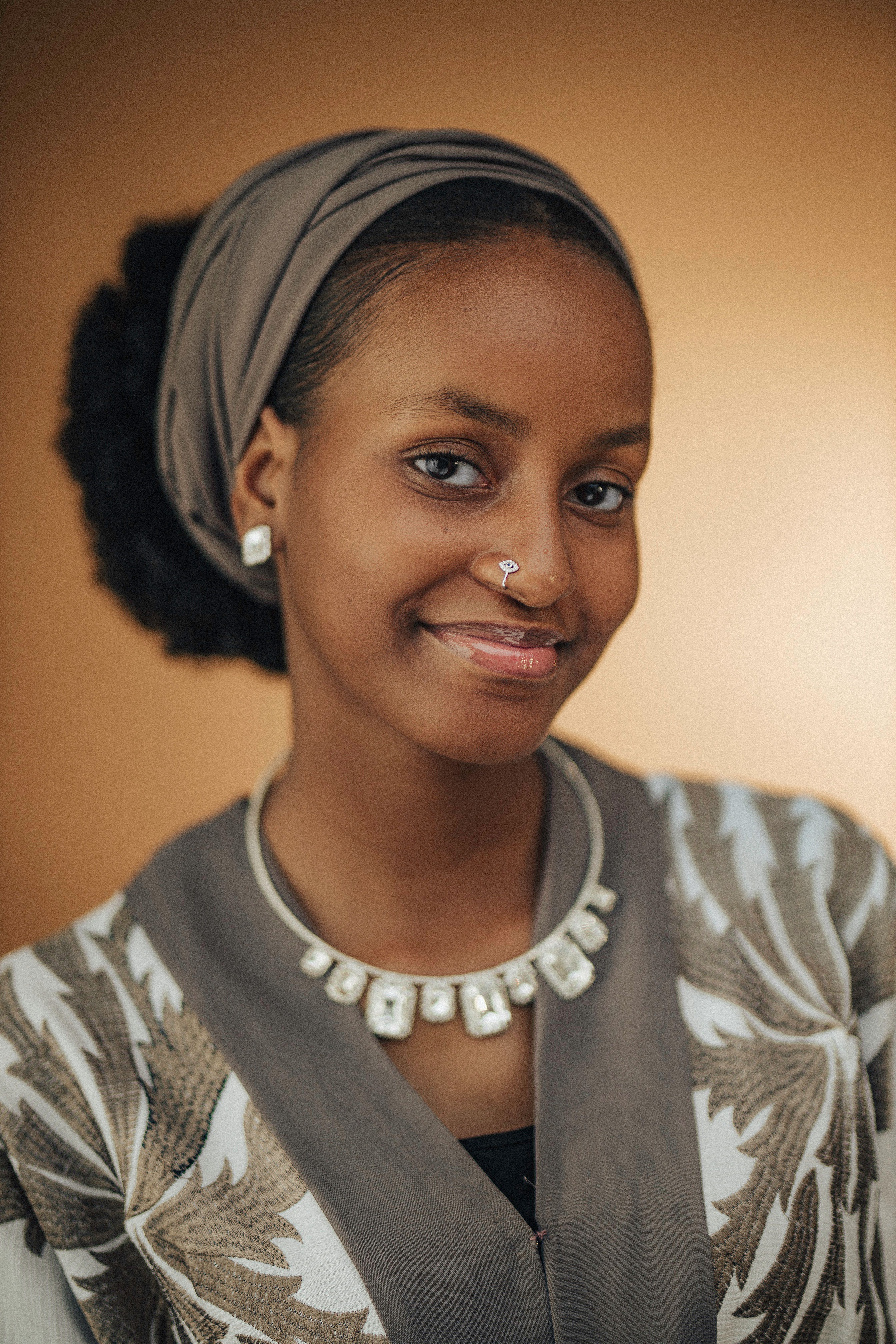 A beautiful portrait of an African woman in Nigeria wearing traditional attire with a warm smile.