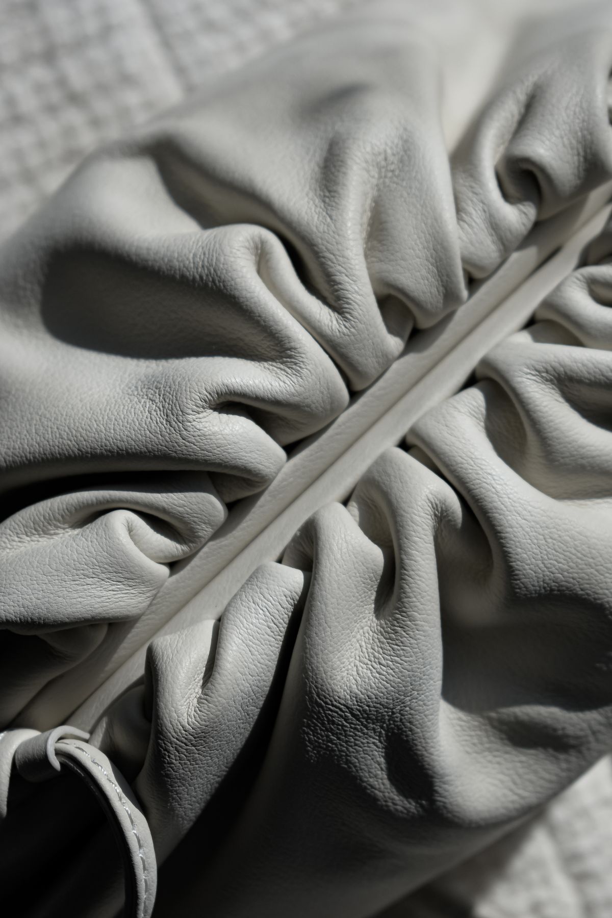 A close-up of a white leather purse, soft and beautiful
