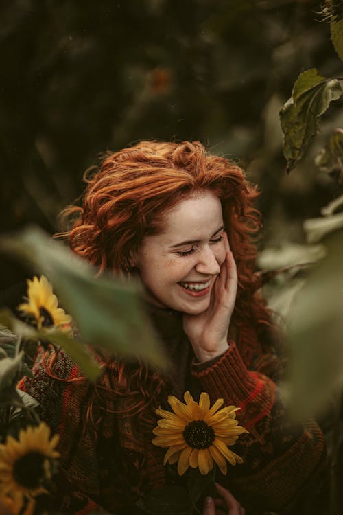 Woman Smiling among Sunflowers