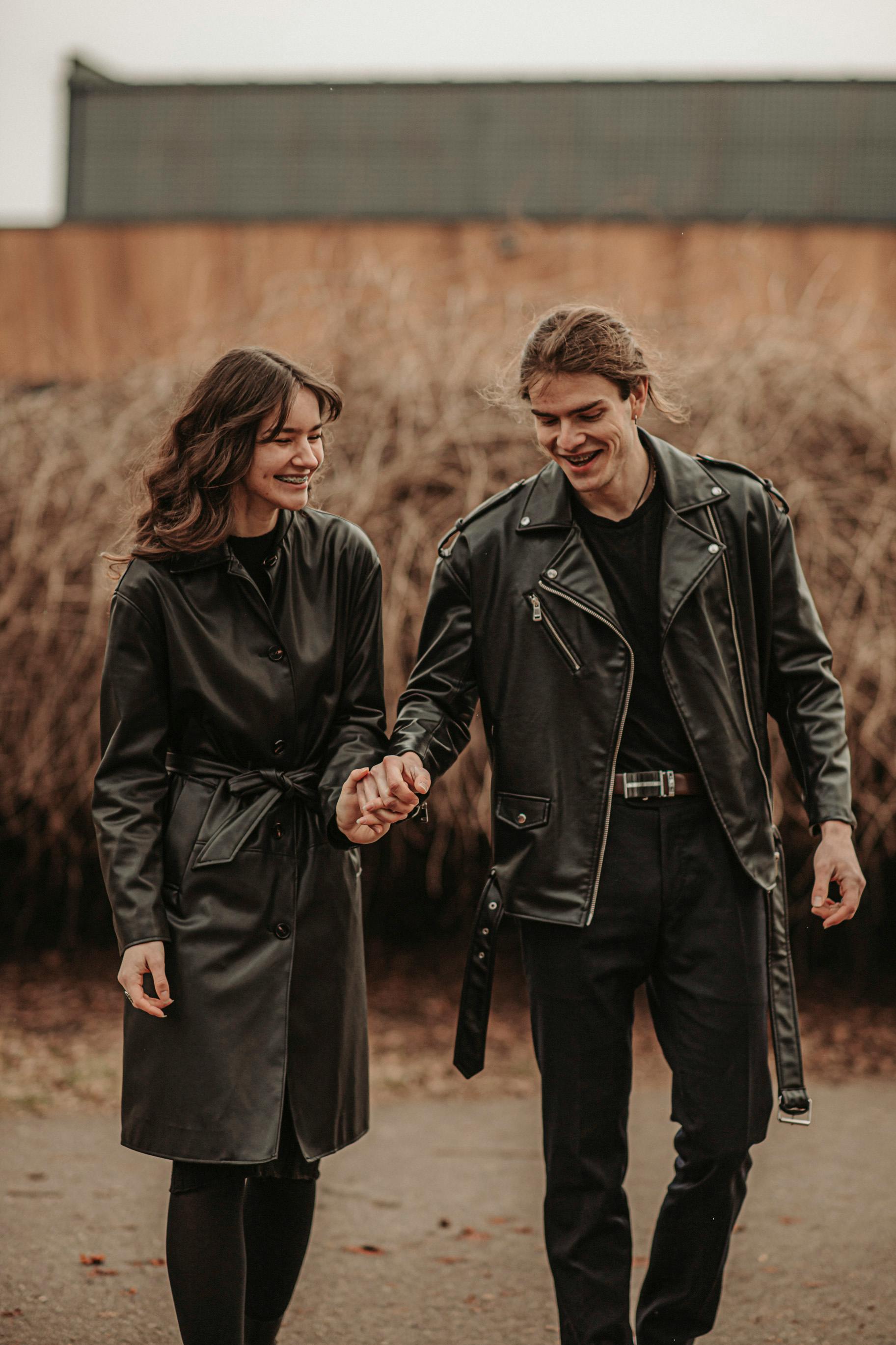 A Couple in Black Leather Jackets Posing by a Car · Free Stock Photo