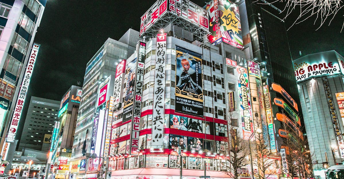 Billboard: Number_i's 'BUGS LIFE' Debuts at No. 1 on Japan Hot 100; Mack Keane Named July R&B Up-and-Comer Dynamic view of Akihabara's illuminated streets at night showcasing neon signs and bustling city life in Tokyo.