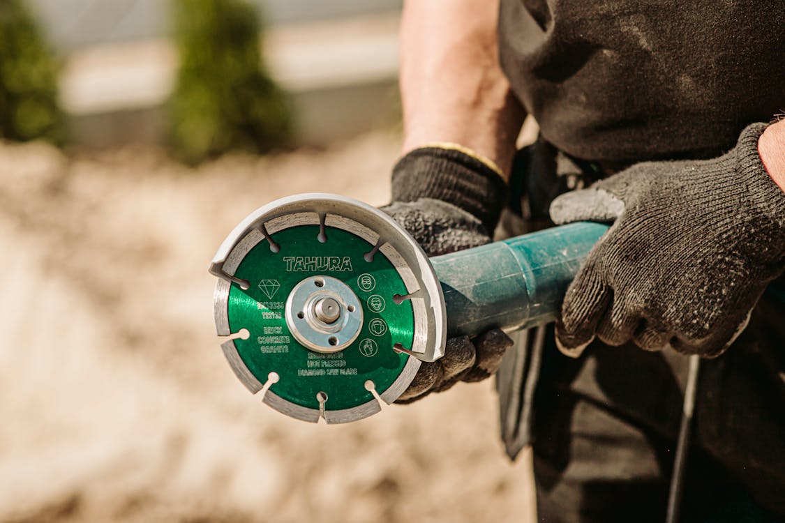 Green Angle Grinder in Hand