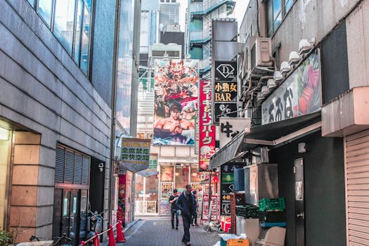Vibrant urban alley filled with signs and people walking. Captures energetic city life.