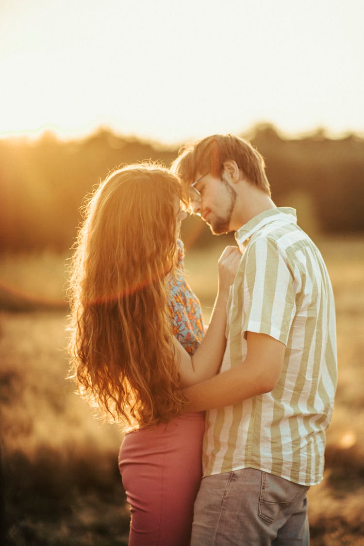 Young Couple Embracing On Meadow