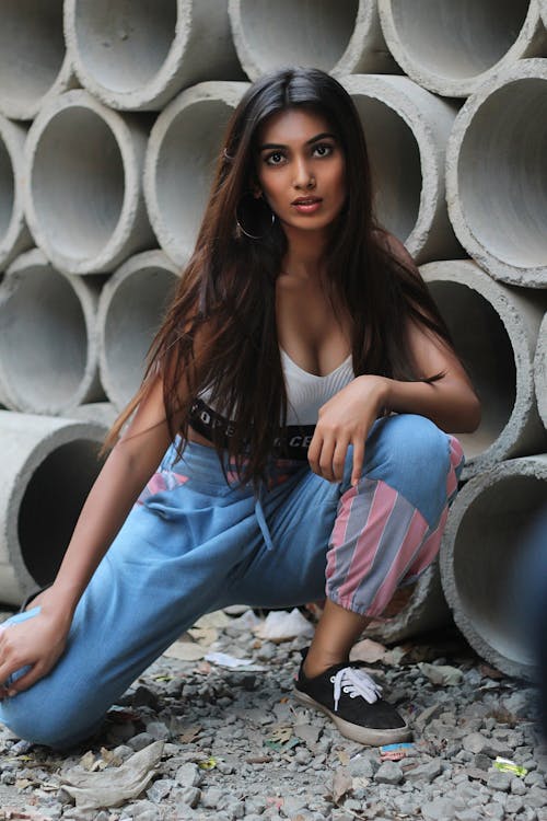 Woman in White Tank Top and Blue Track Pants