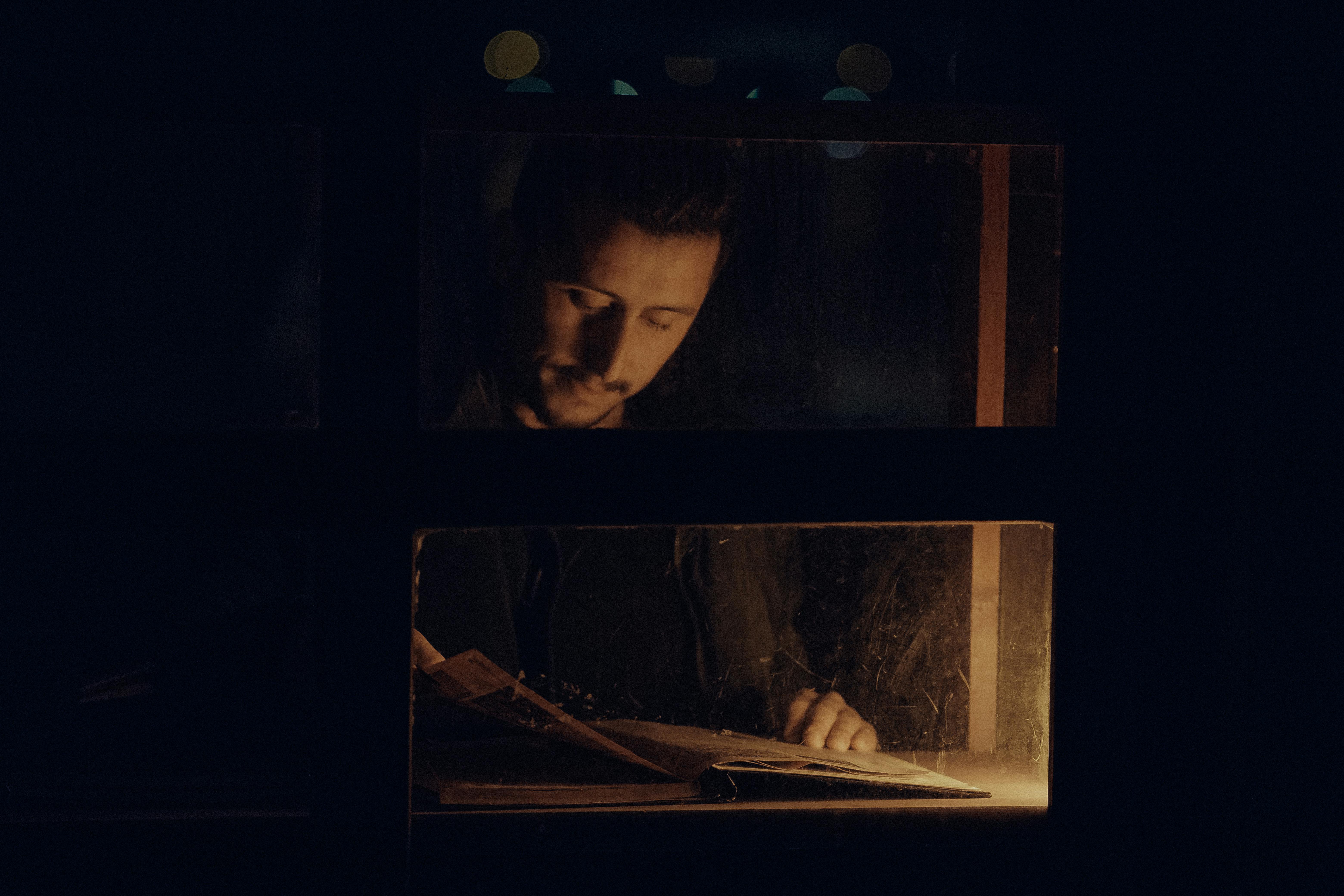 man reading by window