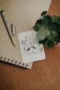 A drawing of a woman and a plant on a notebook