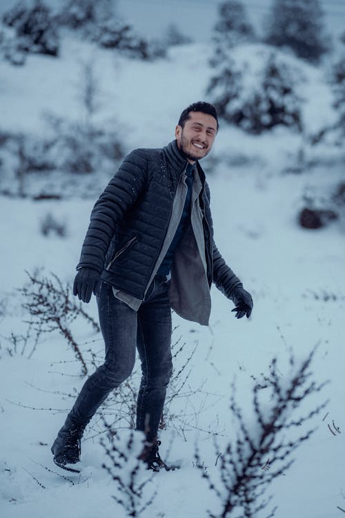 Happy Man Walking Outdoors in Snow 