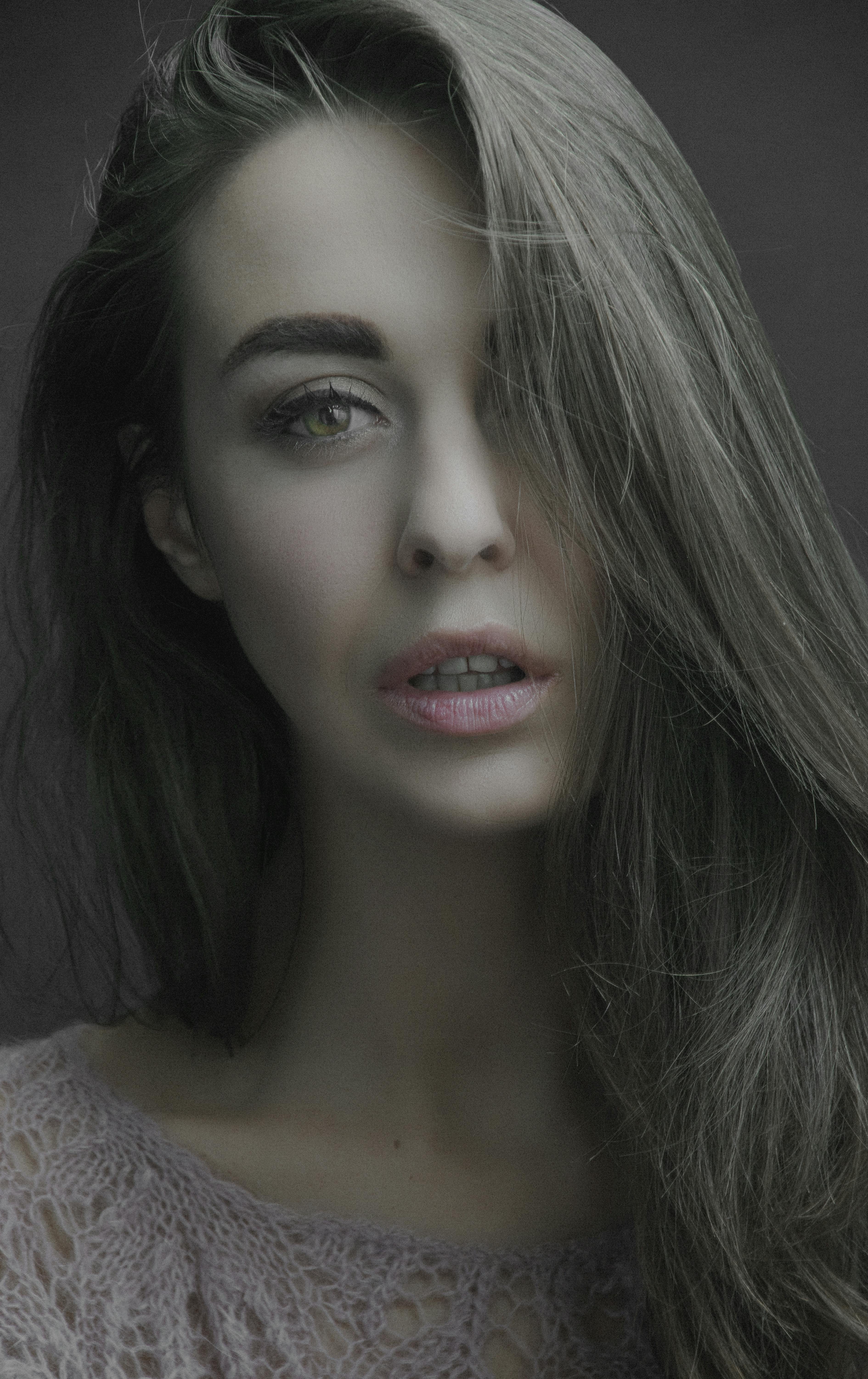 Portrait of a woman with long brown hair and a serene expression.