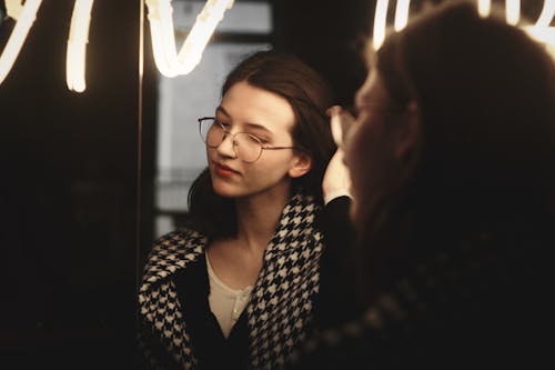 Reflection of a Pretty Brunette Wearing Eyeglasses