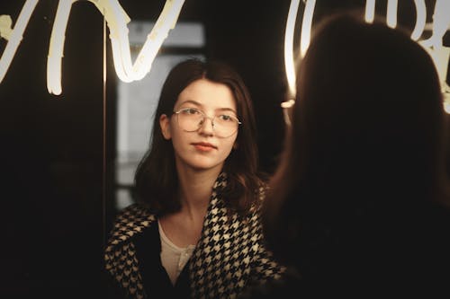 Reflection of Woman in Eyeglasses in Mirror