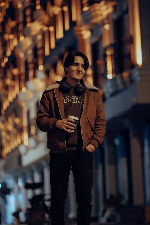 Smiling Man Posing in Jacket at Night