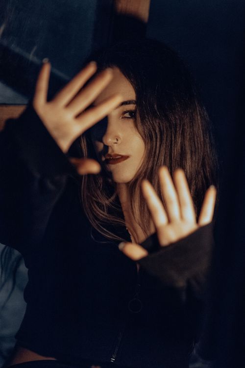 Free Moody fashion portrait of a woman with dramatic lighting. Stock Photo