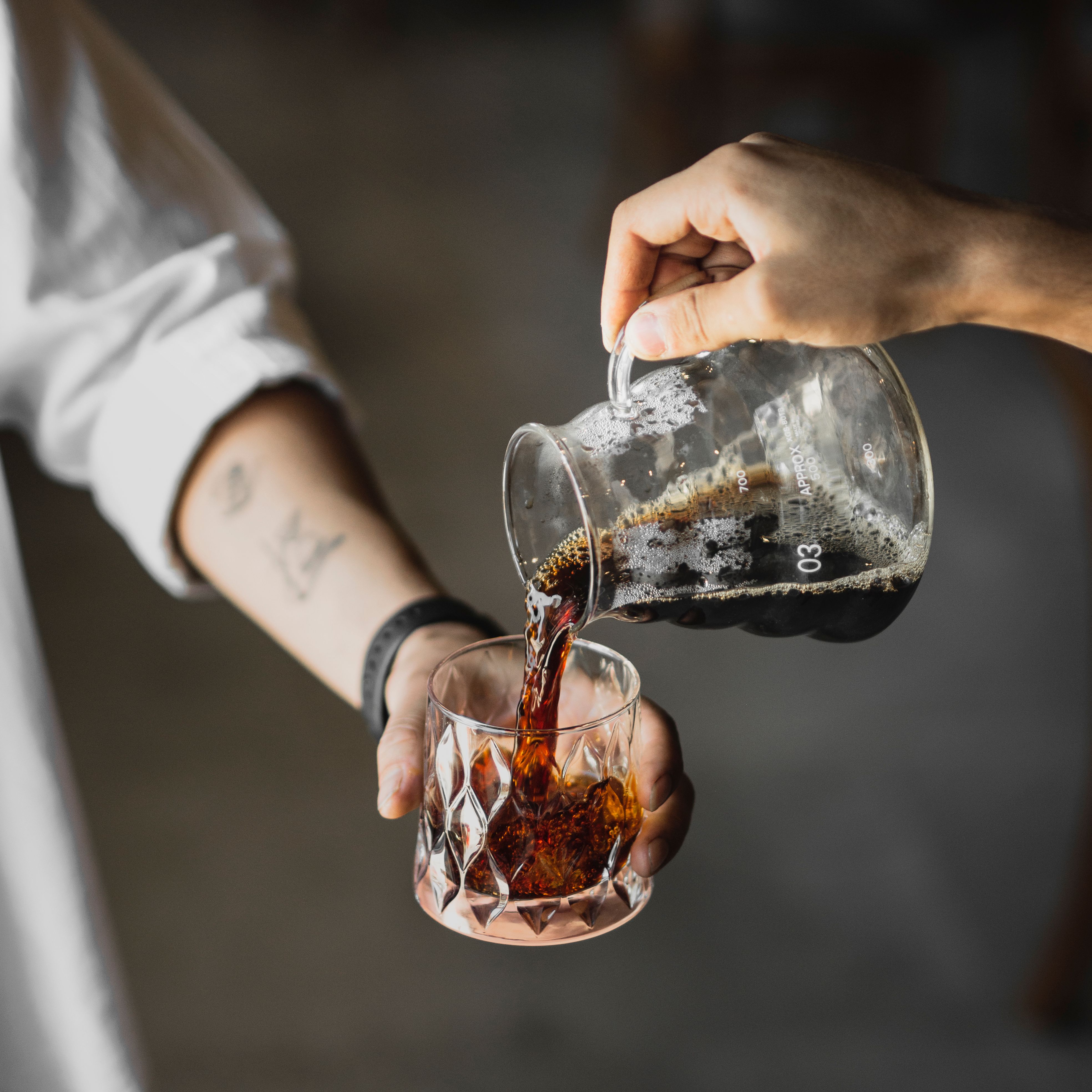 Pouring cold brew coffee from a carafe — photo by Amirho3in tavkoli on Pexels