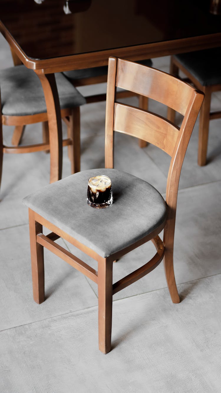 Glass With Beverage On Wooden Chair