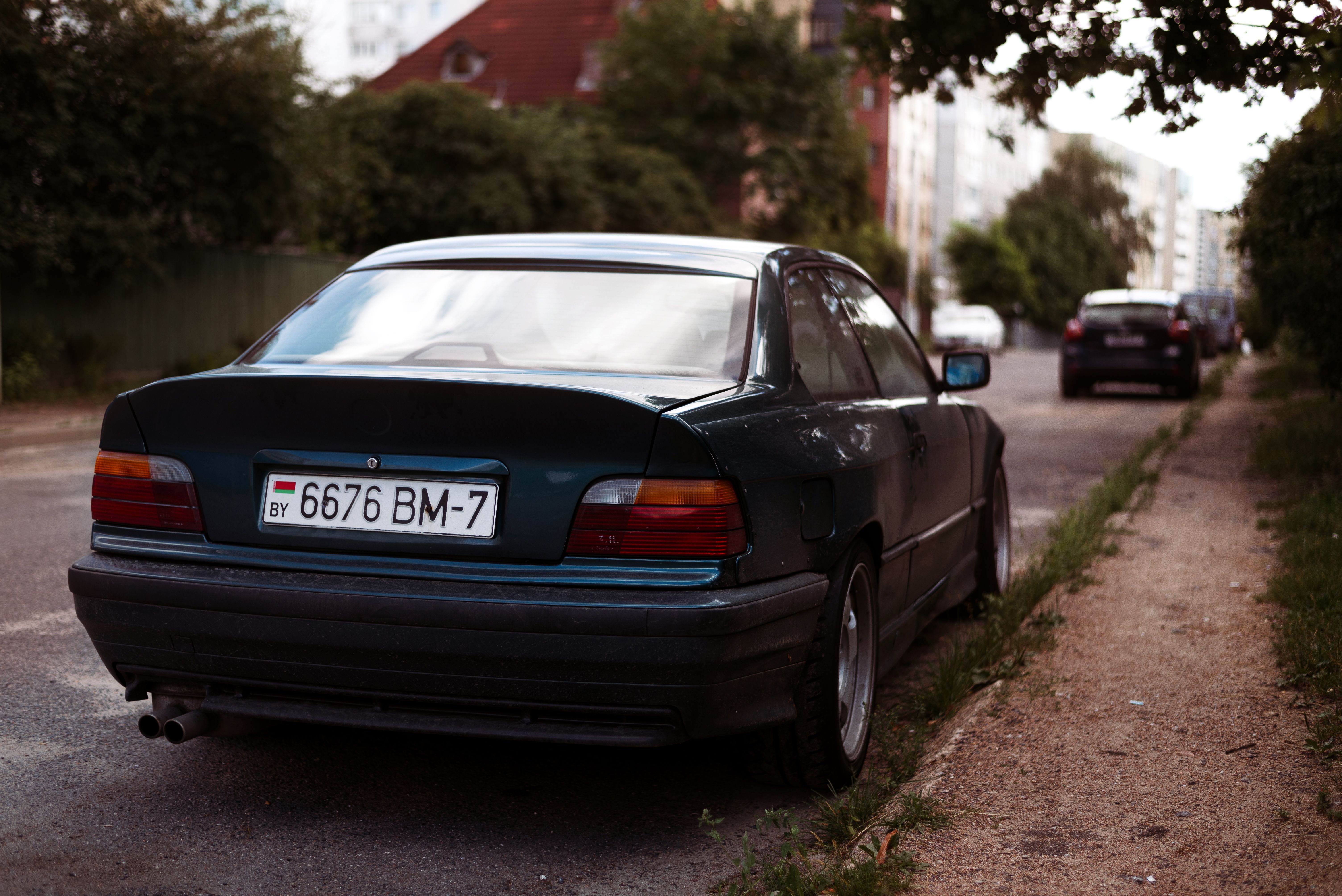 a license plate on a car parked in the street.