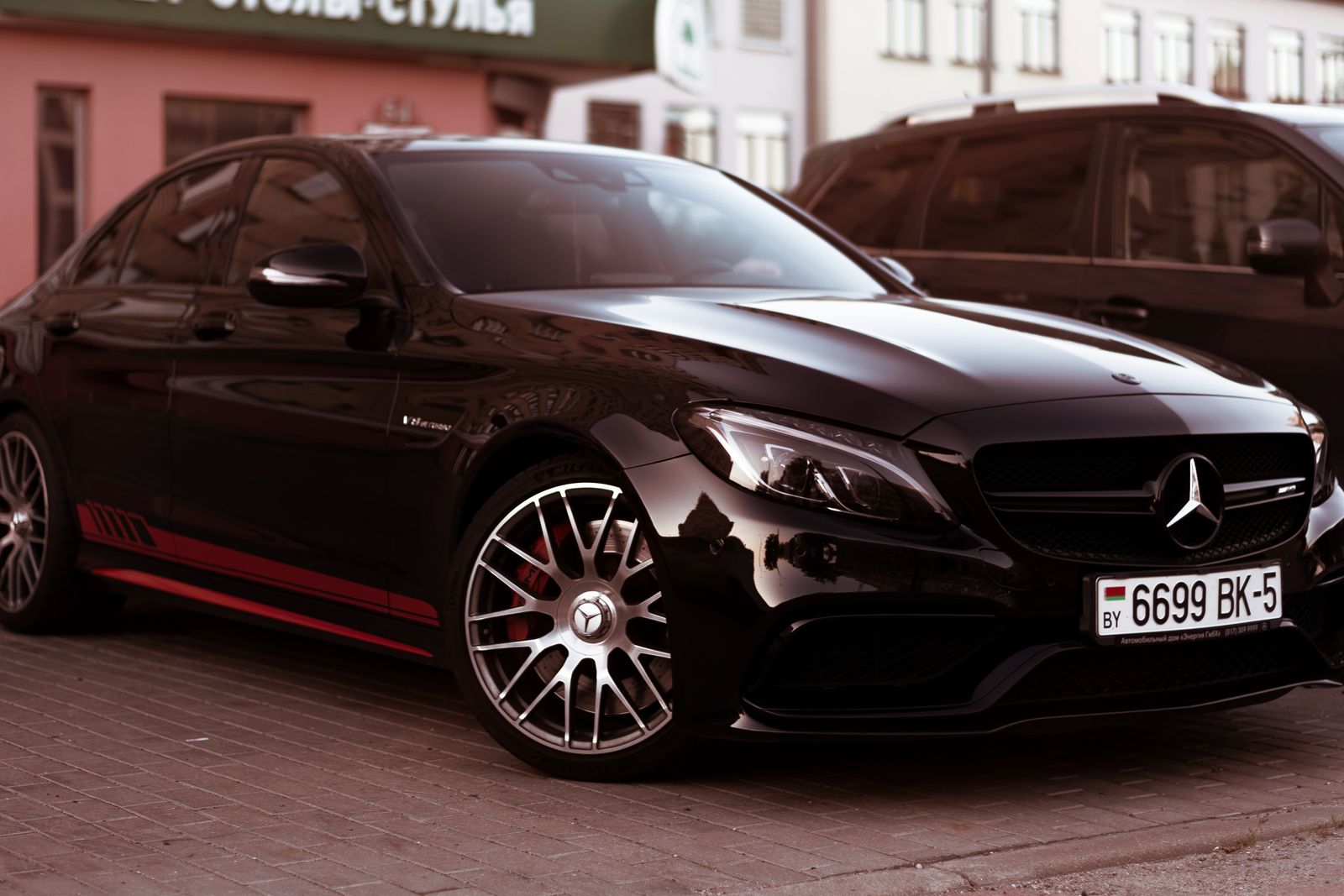 Chauffeur opening the door of an executive Mercedes for a client in Leeds, West Yorkshire