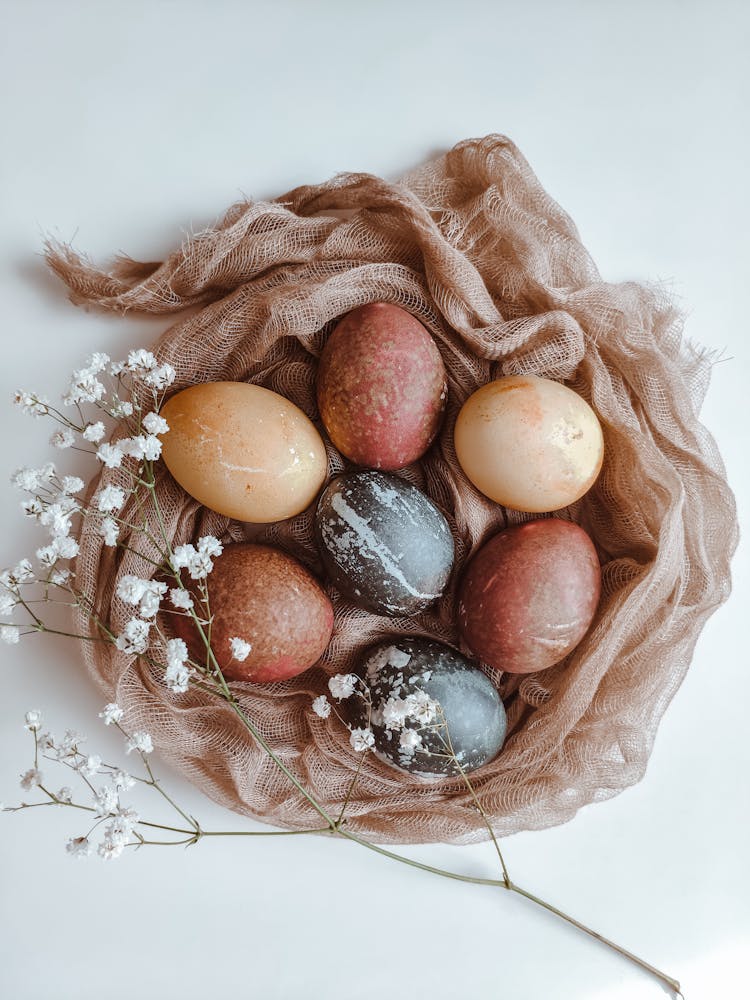 Painted Eggs Lying In Fabric Nest