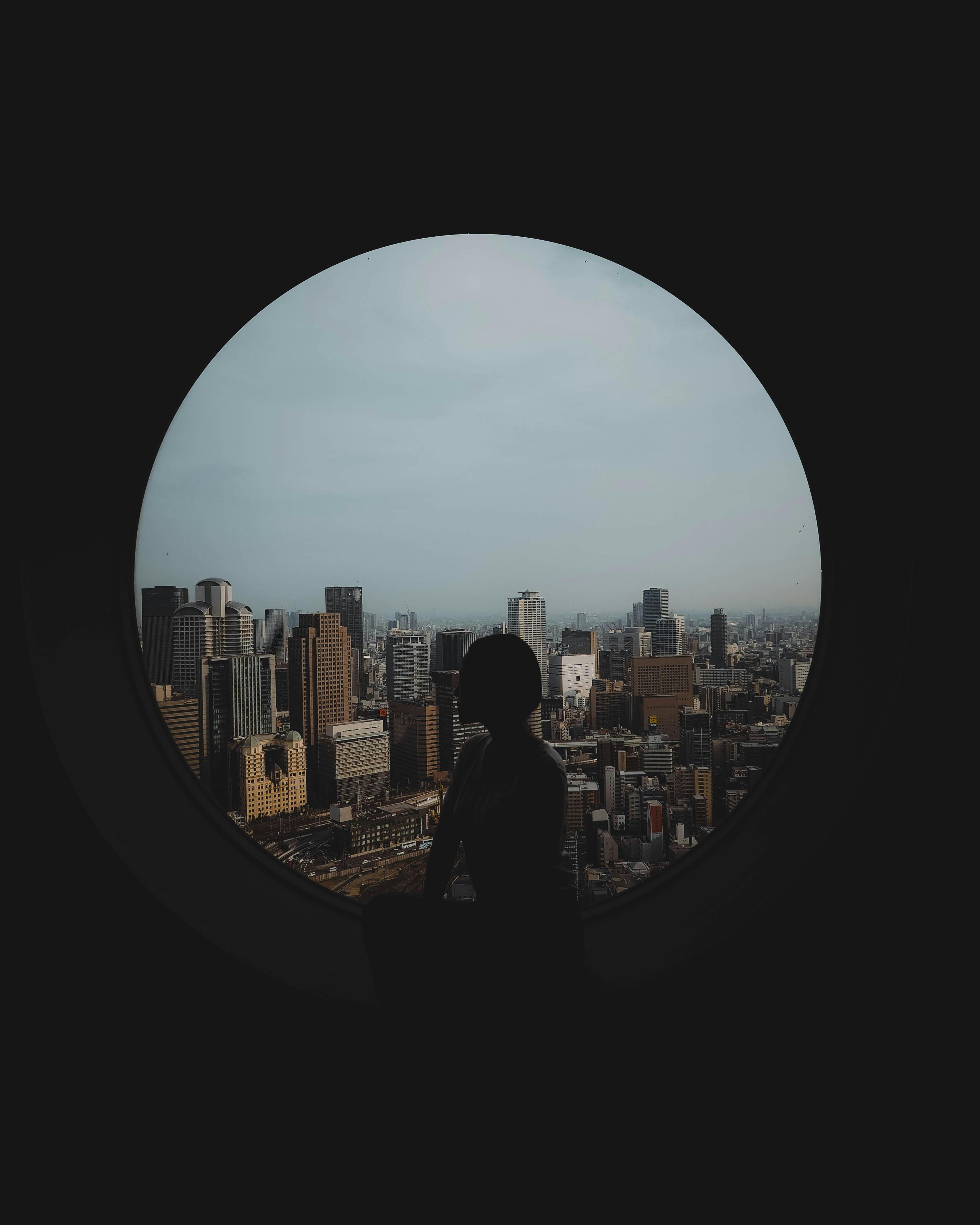 silhouette of woman against window overlooking tokyo