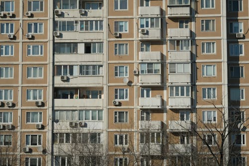 Sunlit Building with Apartments Wall