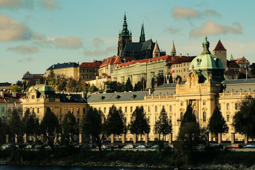 Explore the iconic Prague Castle and St. Vitus Cathedral under a clear sky in vibrant Prague, Czech Republic.