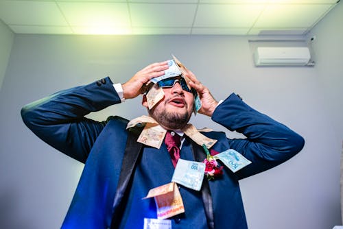 Man Posing with Cash on Suit and Face