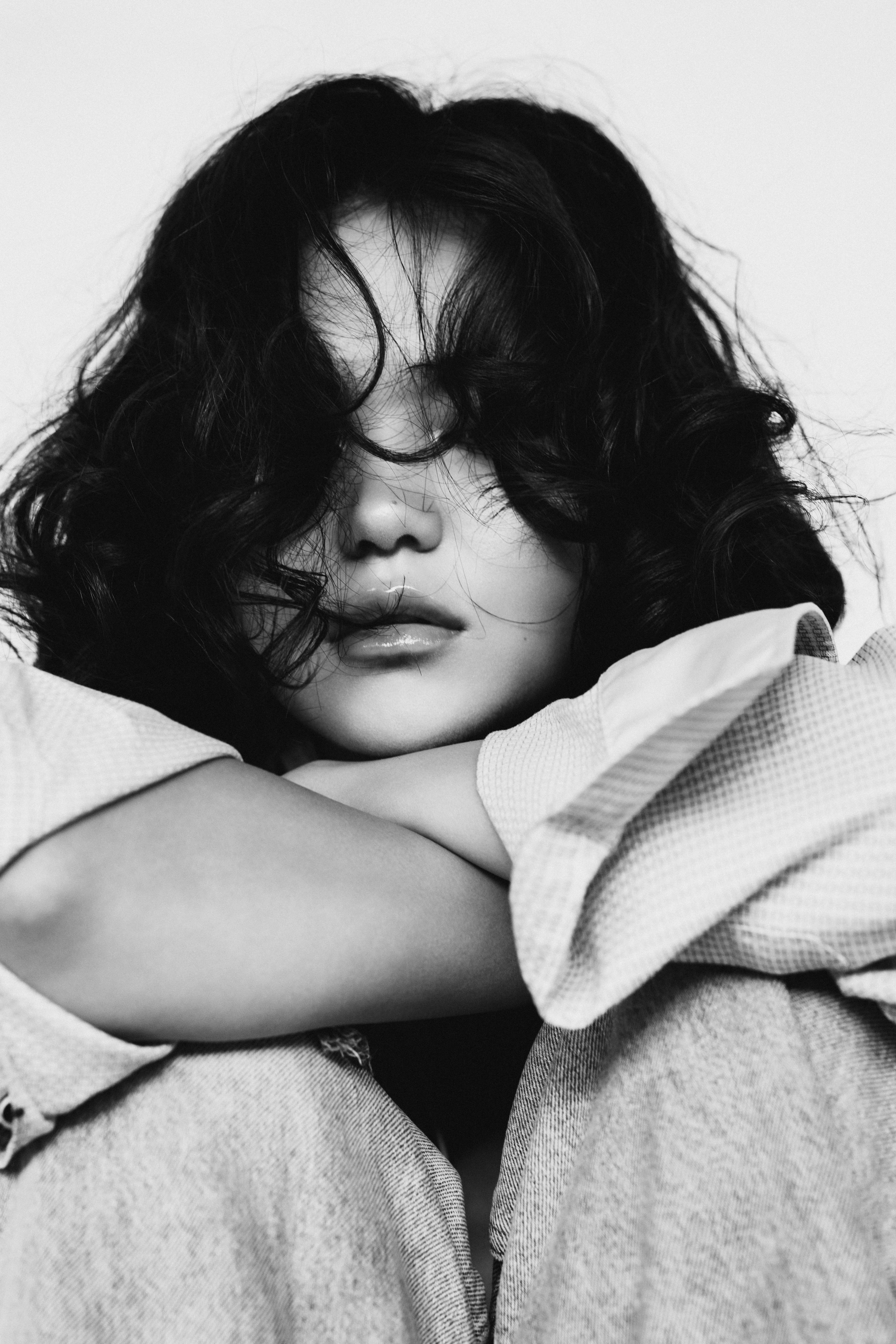 Artistic black and white portrait of a woman with expressive emotions.