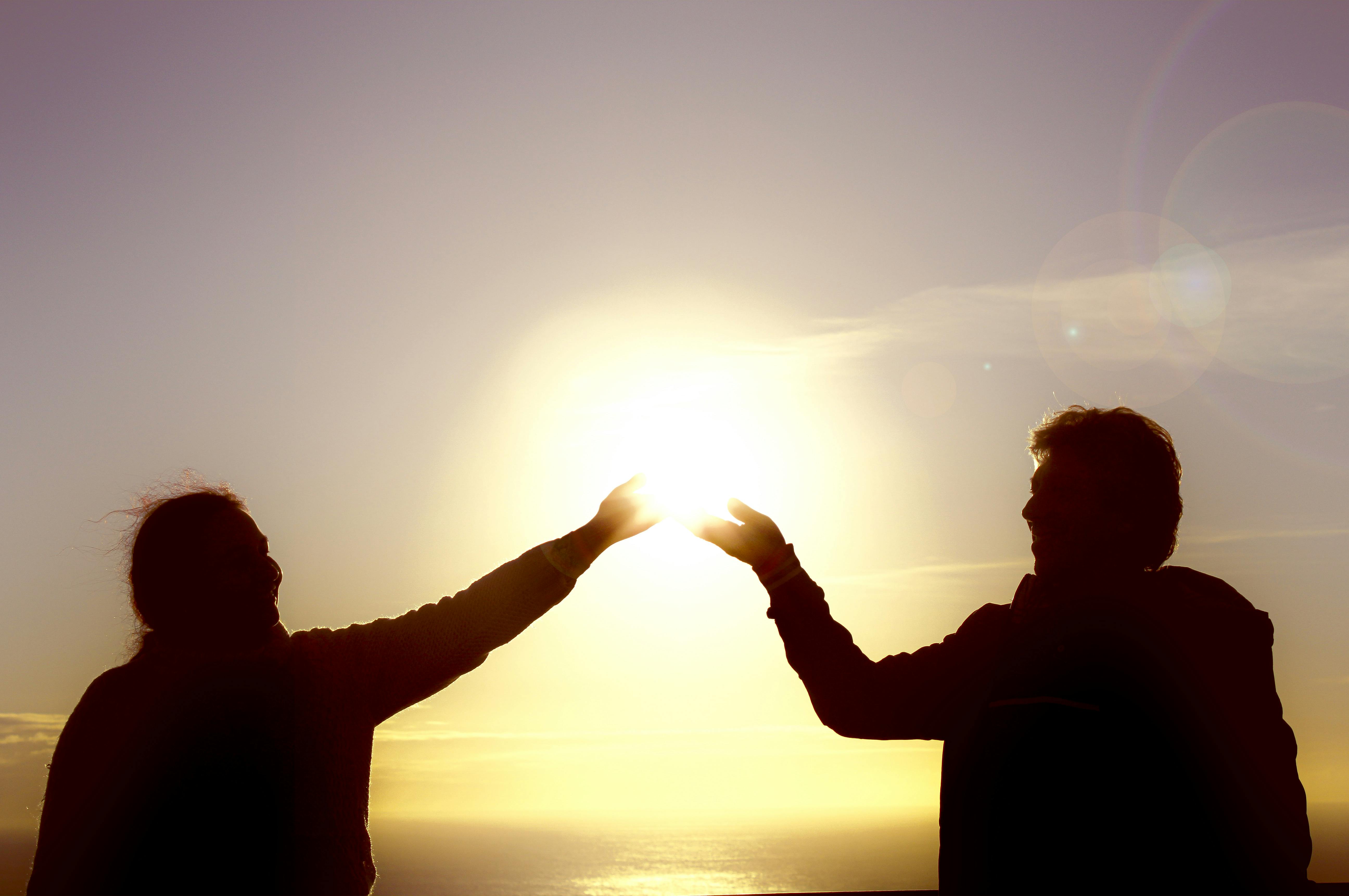 Hopeful Couple Looking At A Sunset
