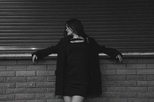 Woman Posing by Wall in Black and White