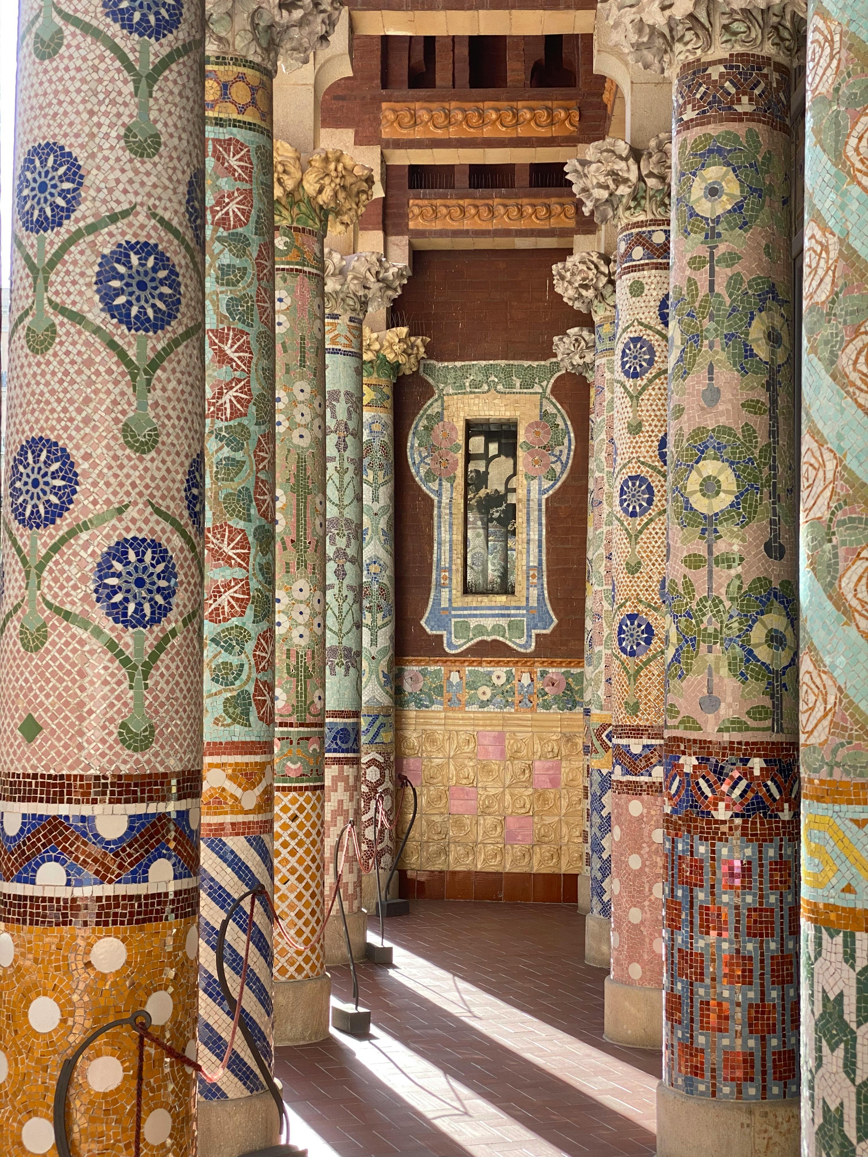 Vibrant mosaic columns at the iconic Palau de la Música Catalana in Barcelona, Spain.
