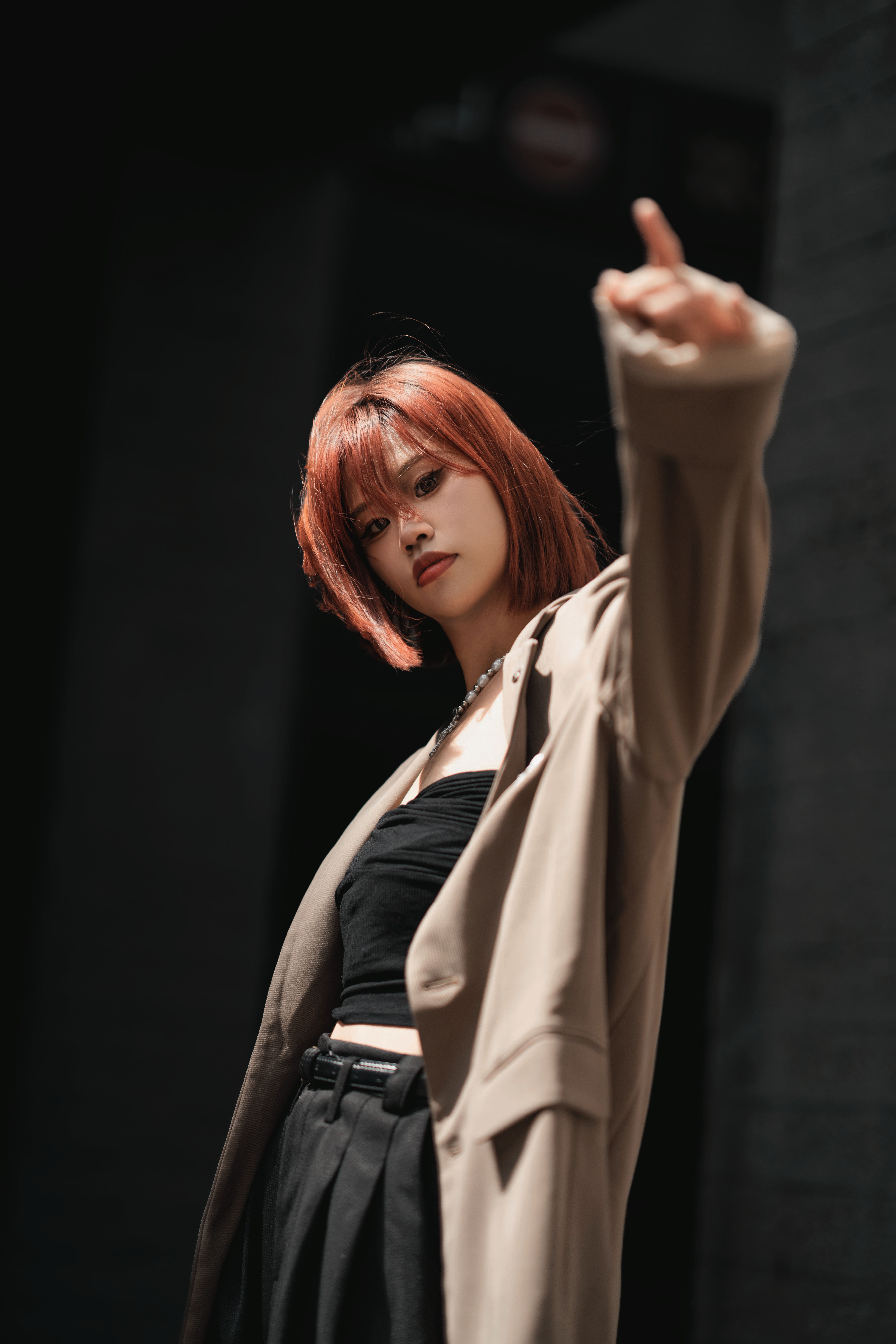 Fashionable young woman posing confidently in trendy urban attire with a modern vibe.