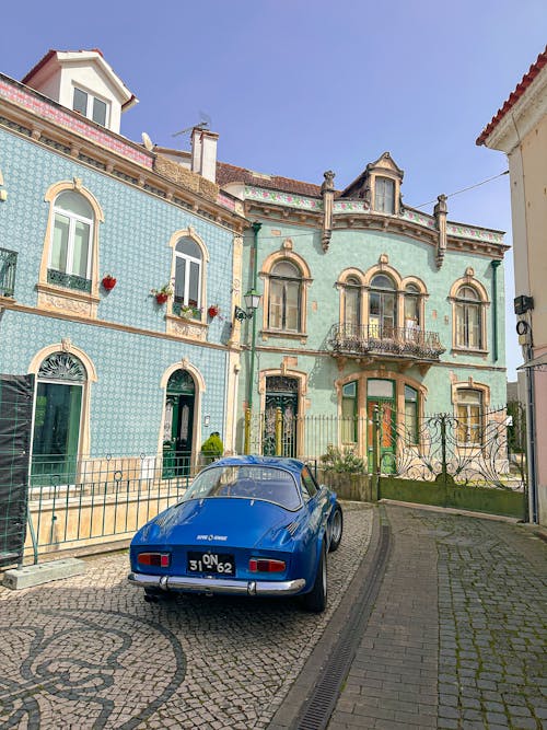 Blue Alpine A110 on Driveway by Mansion