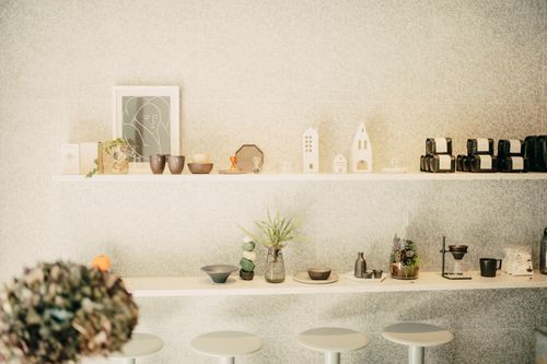 Free Artistic display of modern decor items in a minimalist retail space with soft lighting. Stock Photo