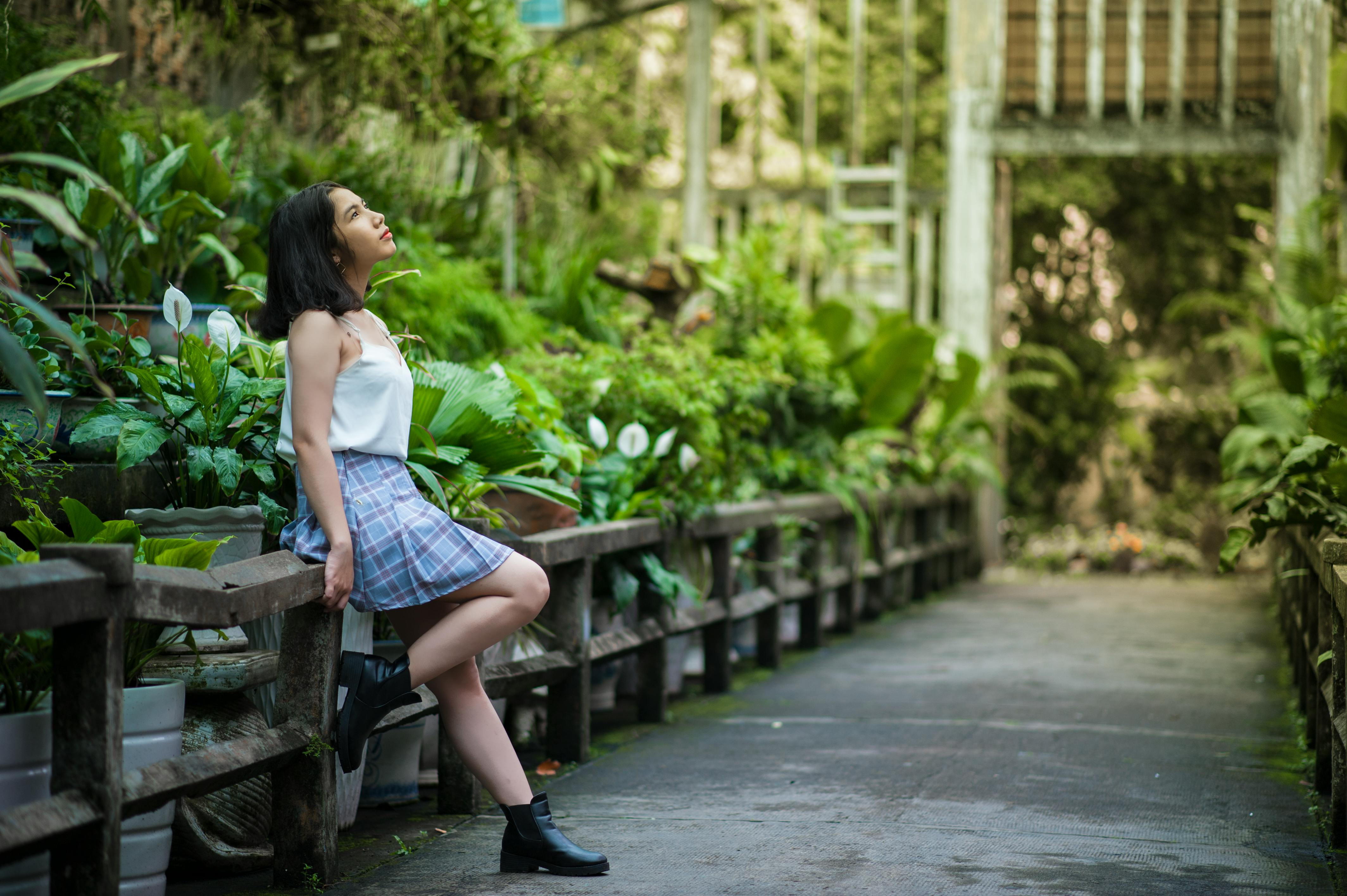 woman sitting on concrete handrail
