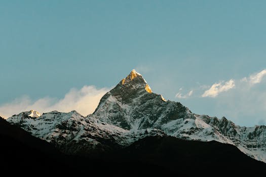 Stunning view of Machapuchare mountain illuminated by sunlight in the Himalayas, Nepal.