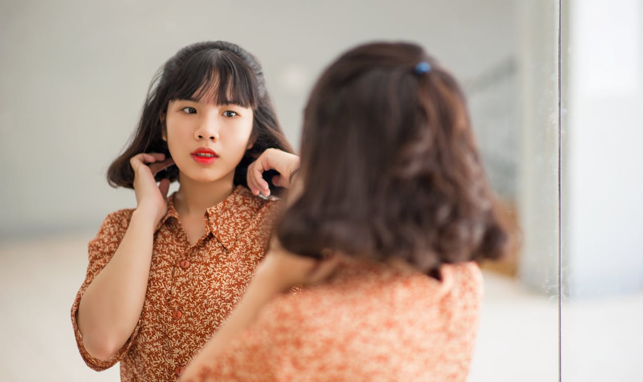 Woman with PCOS in Front of Mirror