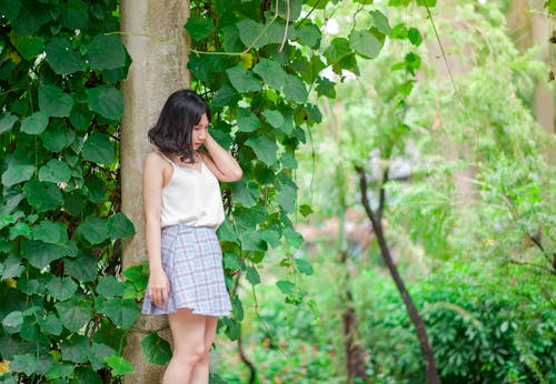 Free Woman Standing Against Tree Stock Photo