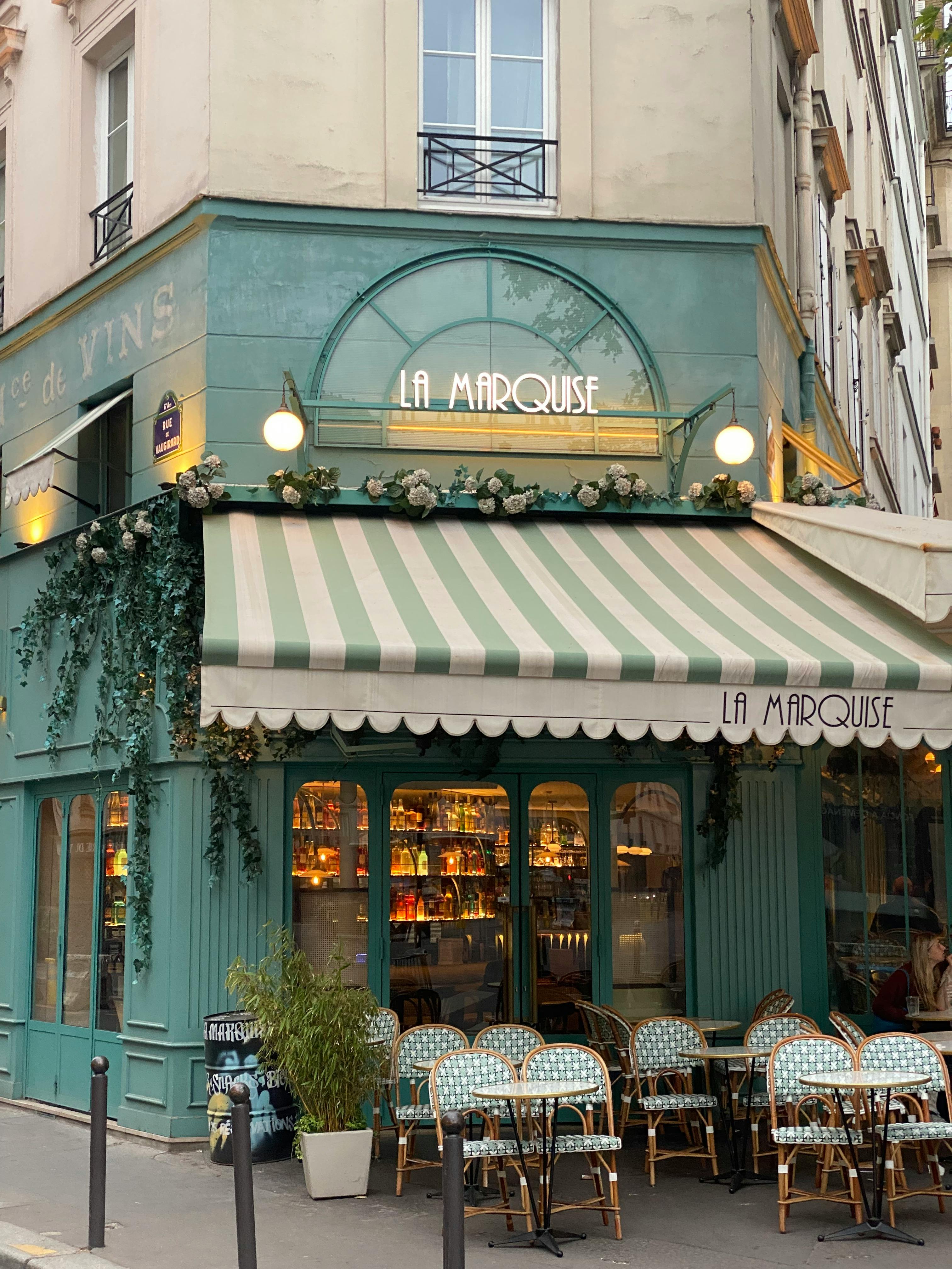 A picturesque outdoor view of La Marquise café in Paris with inviting seating and classic architecture.
