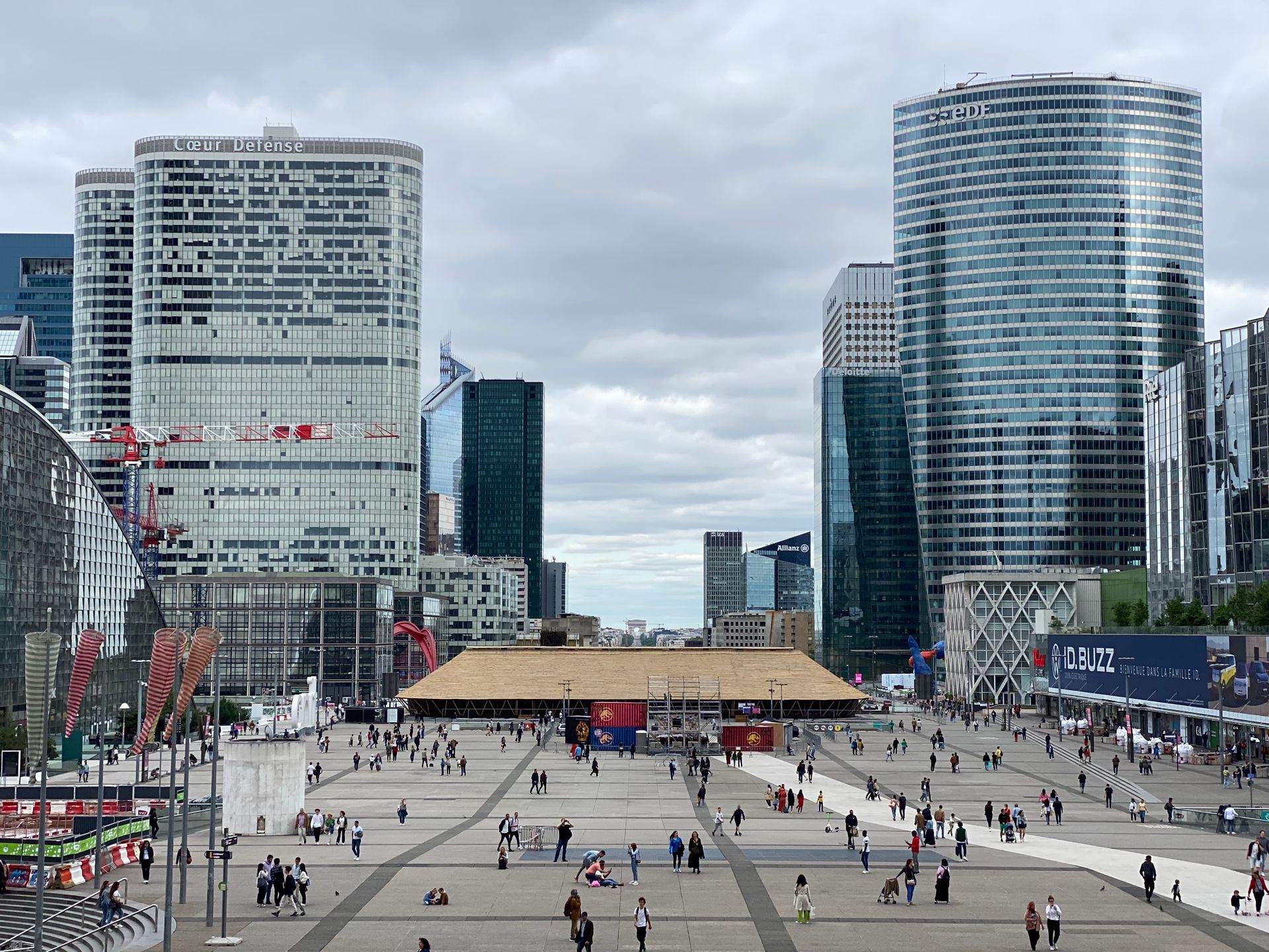 Vibrant scene at La Défense, the modern business hub of Paris with skyscrapers and bustling activity.