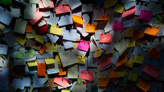 Various colorful sticky notes pinned on a board creating a vibrant display.