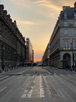 Beautiful sunset over Paris city street, capturing the iconic architecture and urban vibe.