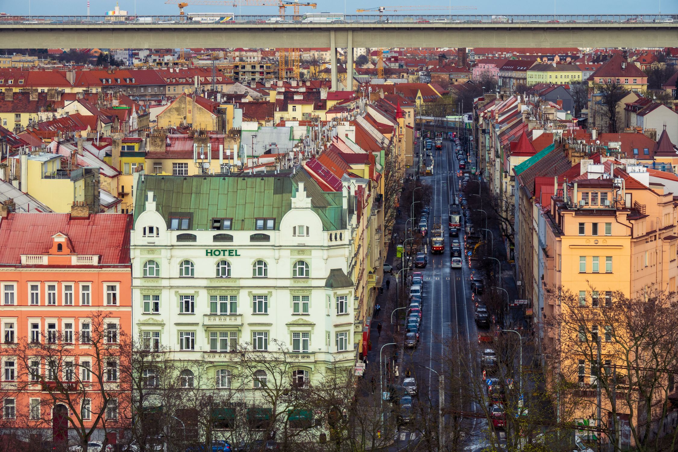 Aerial shot of colorful buildings and streets in Prague, showcasing urban architecture.