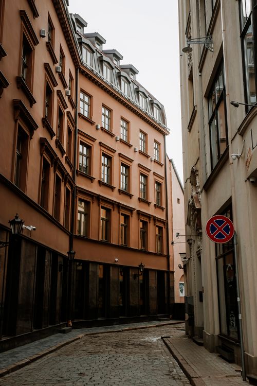 Free Explore a serene narrow street lined with historic tenement buildings in an old European city. Stock Photo