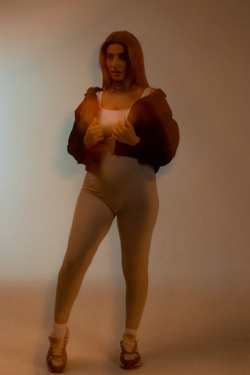 Female Model Wearing a Hooded Shirt Posing in a Studio